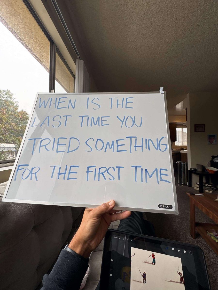 A hand holding a whiteboard that reads: When is the last time you tried something for the first time?